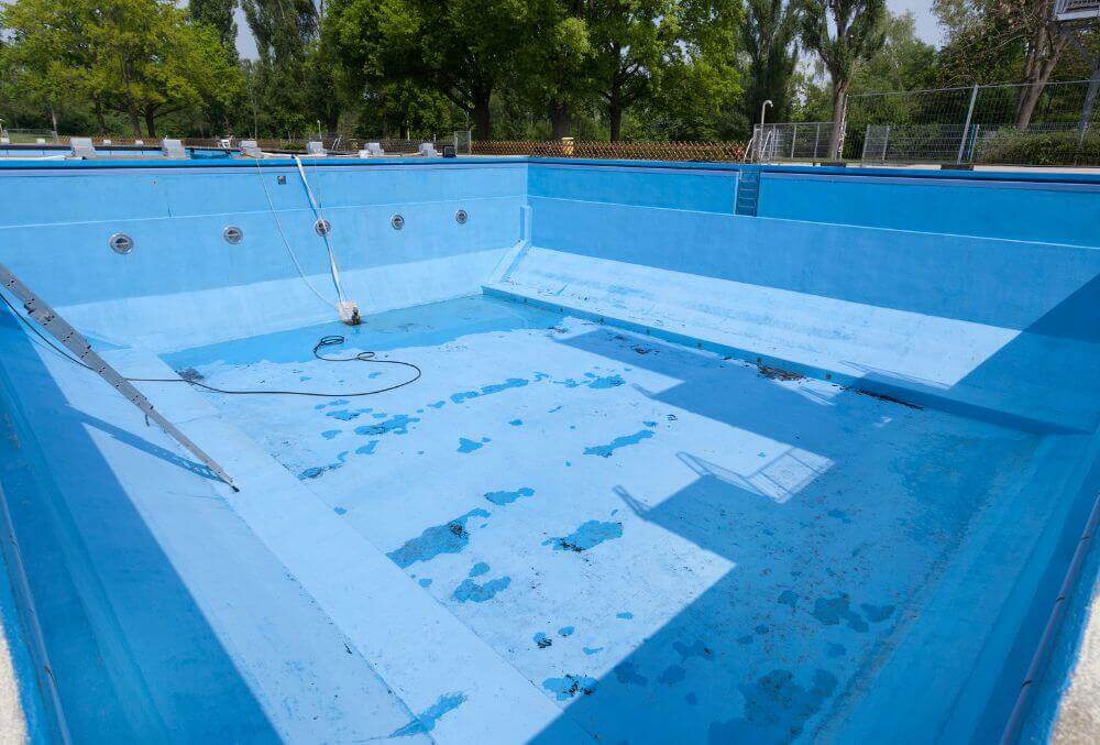 Drained swimming pool under repair