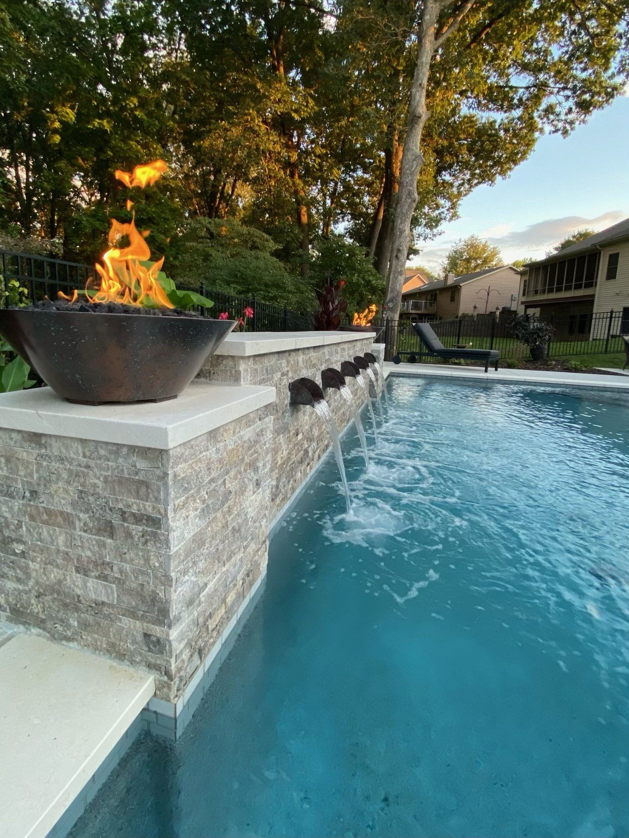 modern fir pit on top on the pool deck