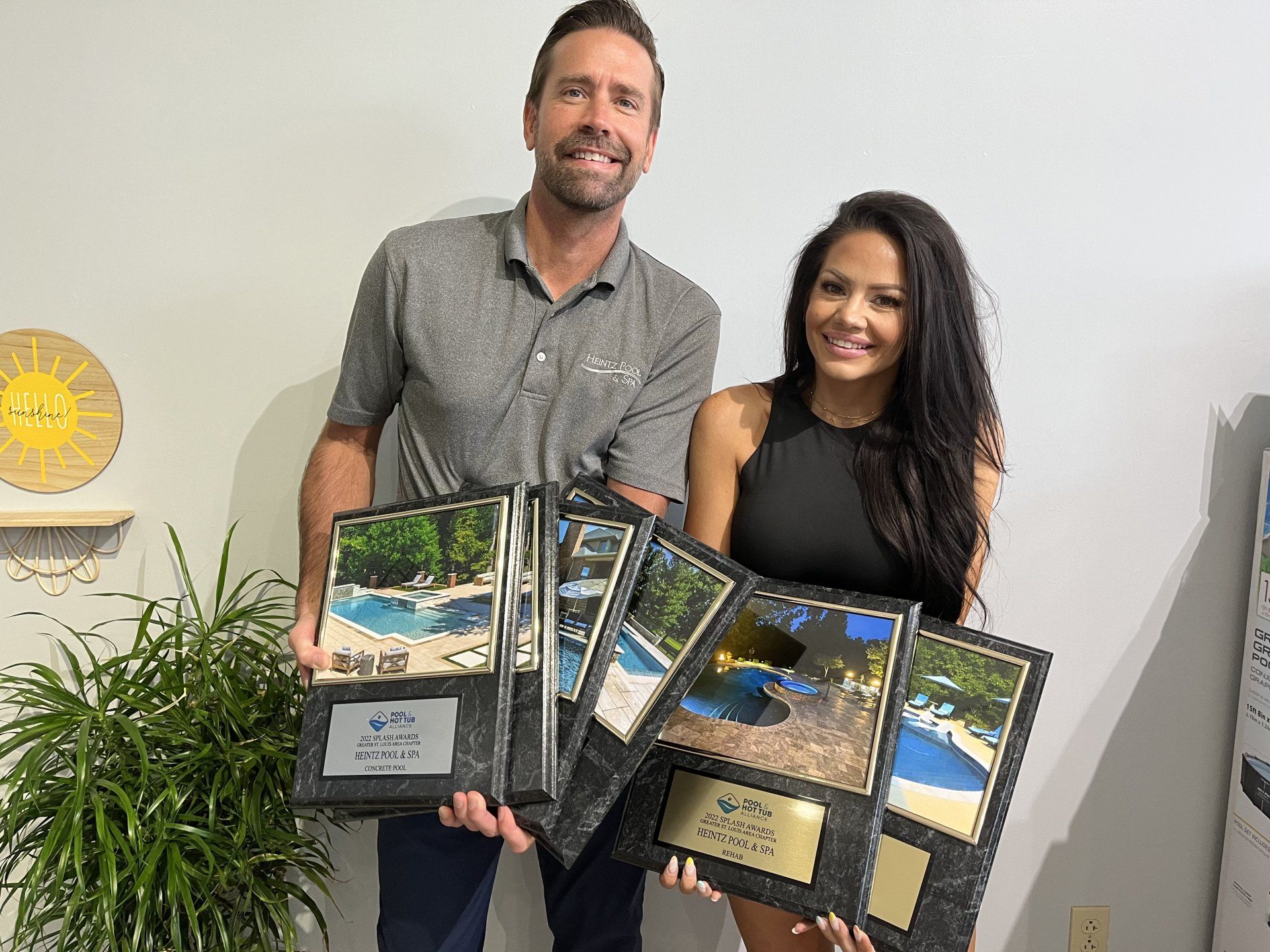 Owner of Heintz Pool & Spa with his partner holding awards for their pool and spa projects