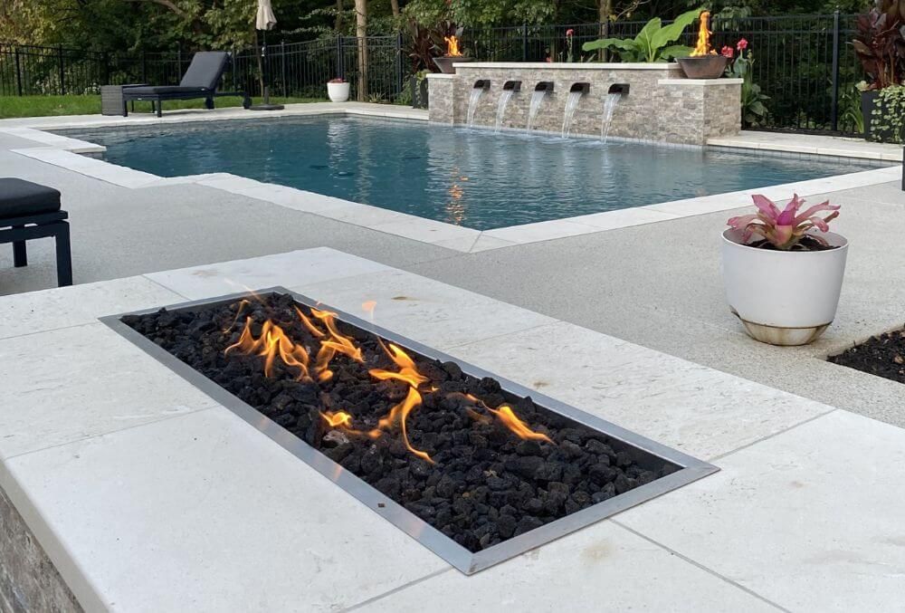 Rectangular charcoal fireplace beside a pool