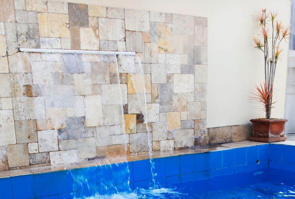 Sheer waterfall feature with natural stones back