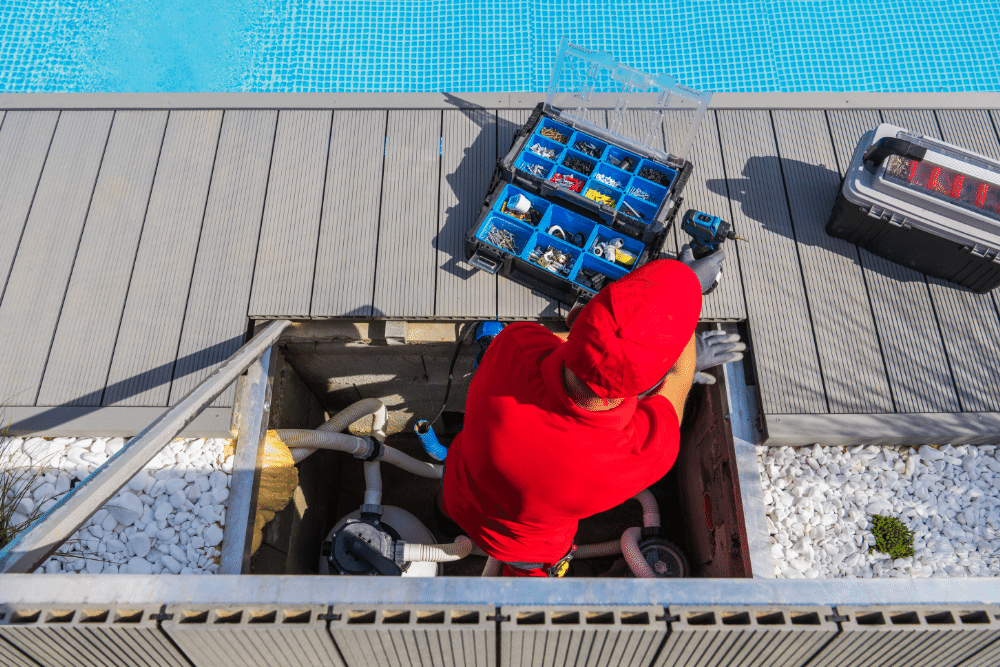 A man performing maintenance tasks on the swimming pool