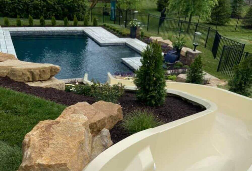 Water pool slide feature in a residential pool