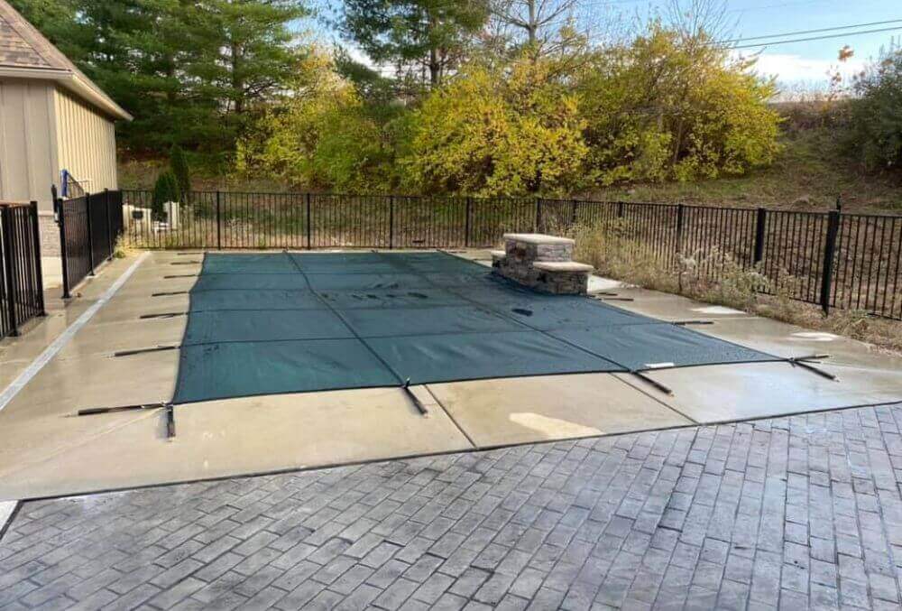 Winterized rectangular pool with cover with nature background