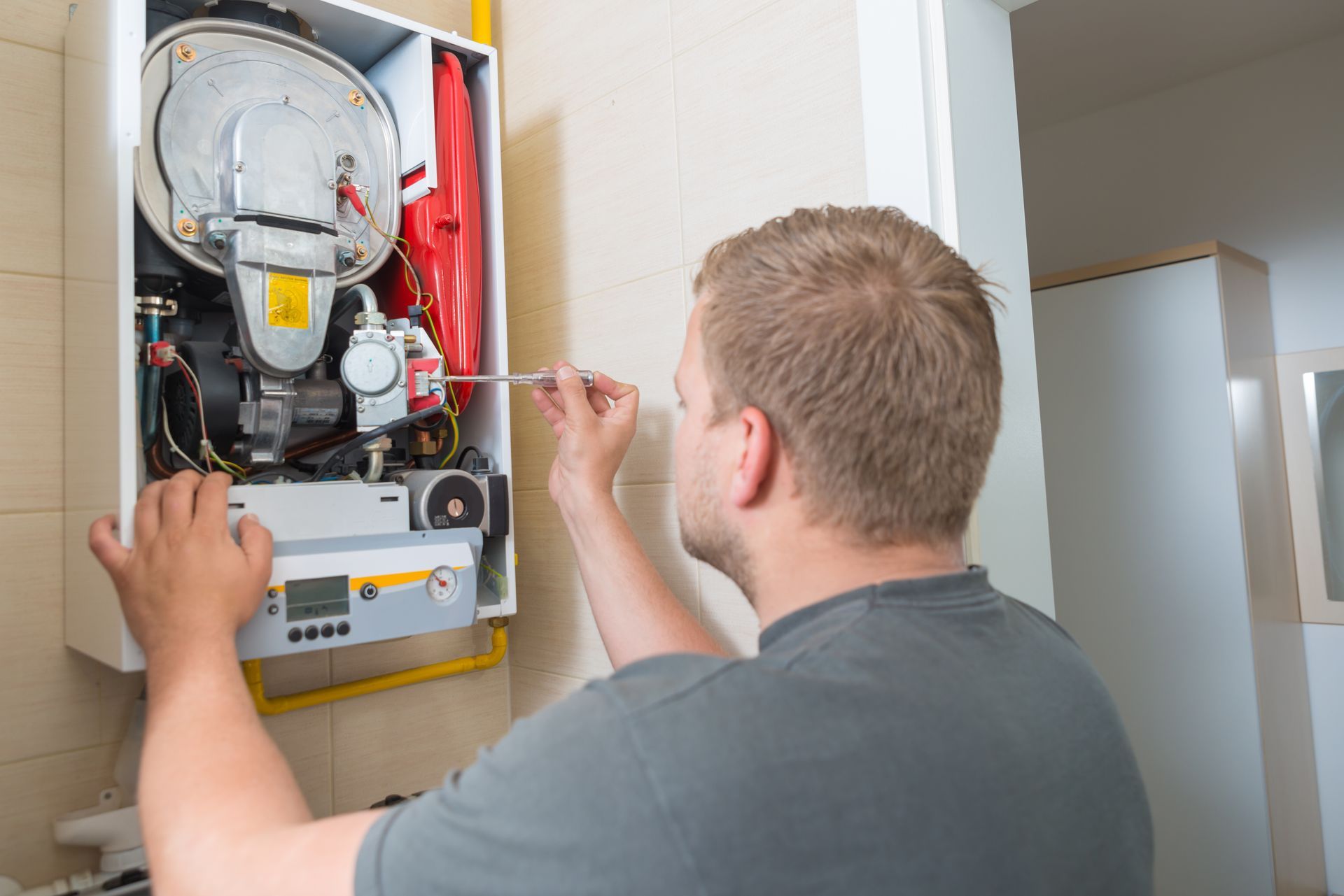 A technician from Moon Air Inc. providing furnace installation services for a residential property i