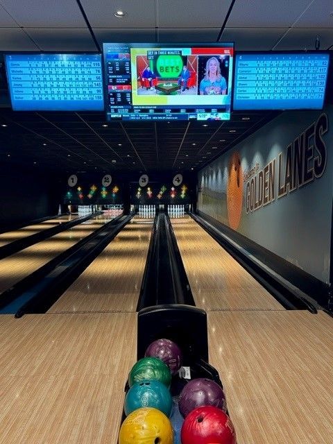 a bowling alley with a sign that says golden lanes