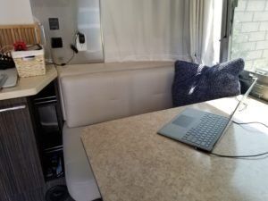 a laptop computer is sitting on a table in a camper .