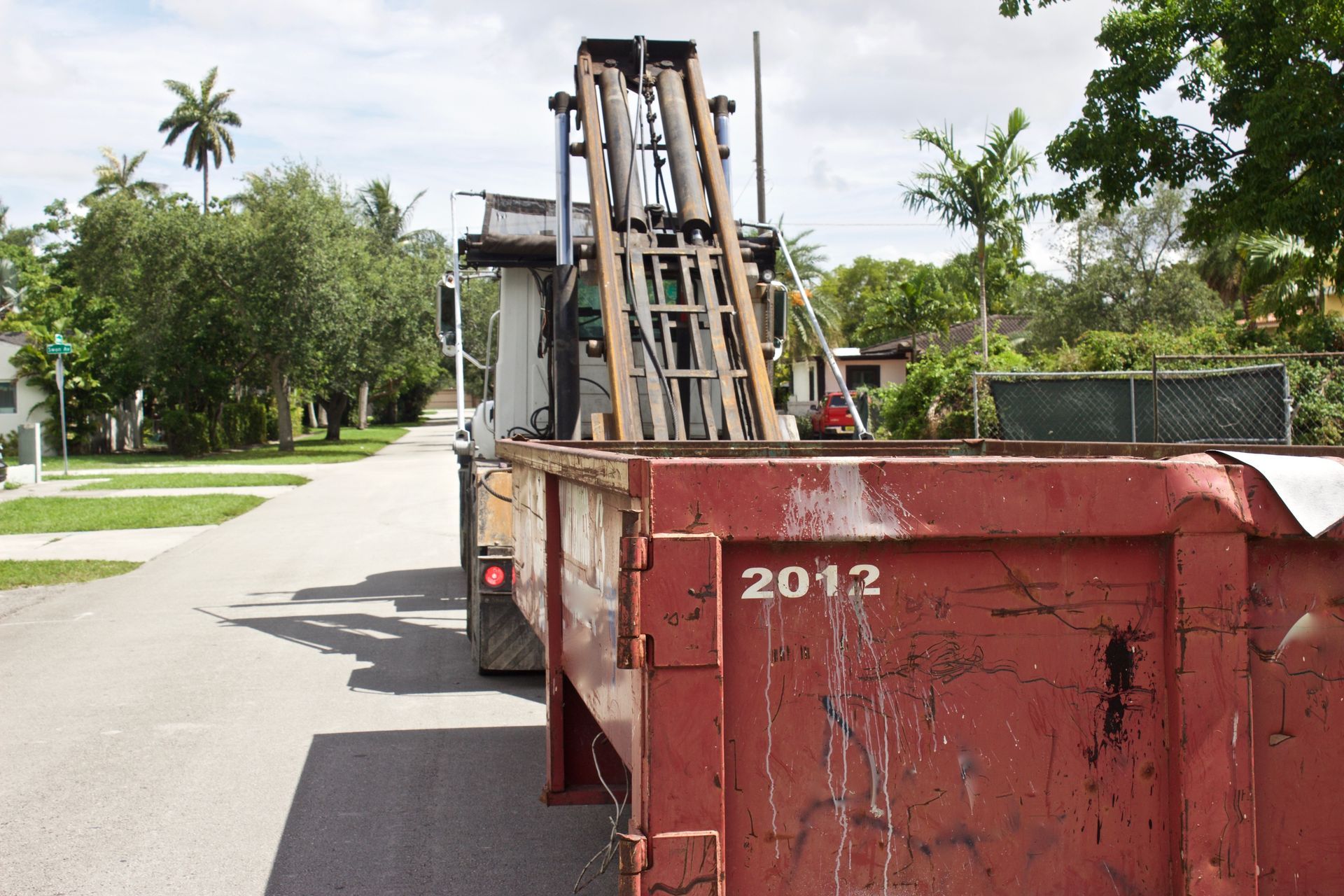 Construction dumpster being unloaded.