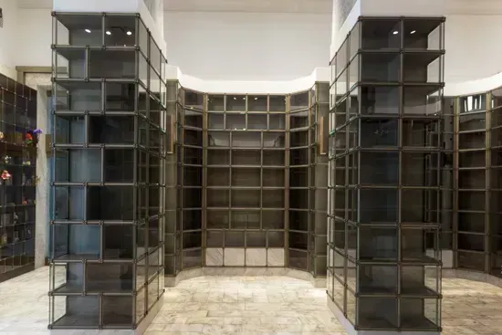 Modern interior with tall black shelving units arranged around a central display wall