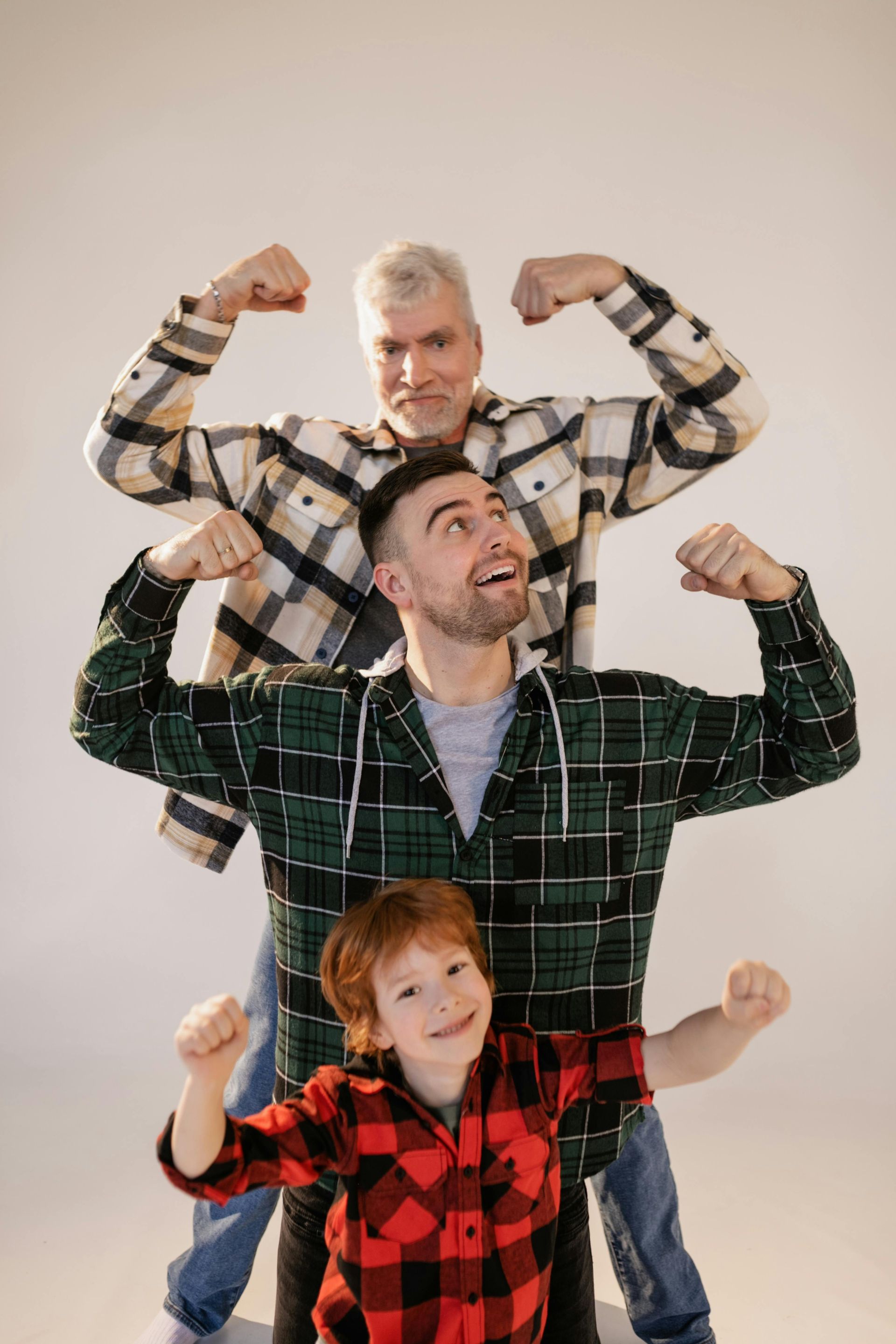 A group of men are posing for a picture and flexing their muscles.