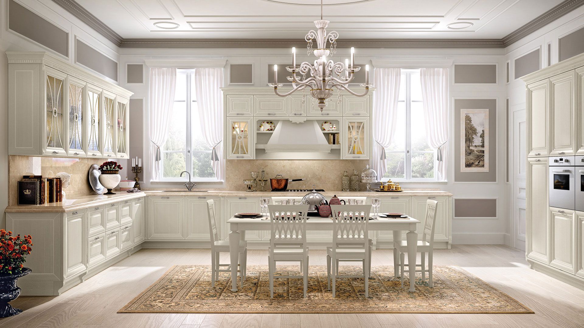 Una cucina con mobili bianchi, tavolo e sedie e un lampadario.