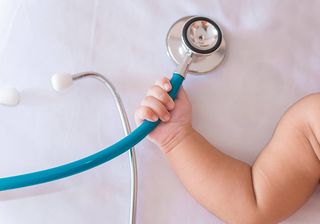 Medical Instruments Stethoscope in Hand of Newborn Baby Girl in Fredericksburg, VA