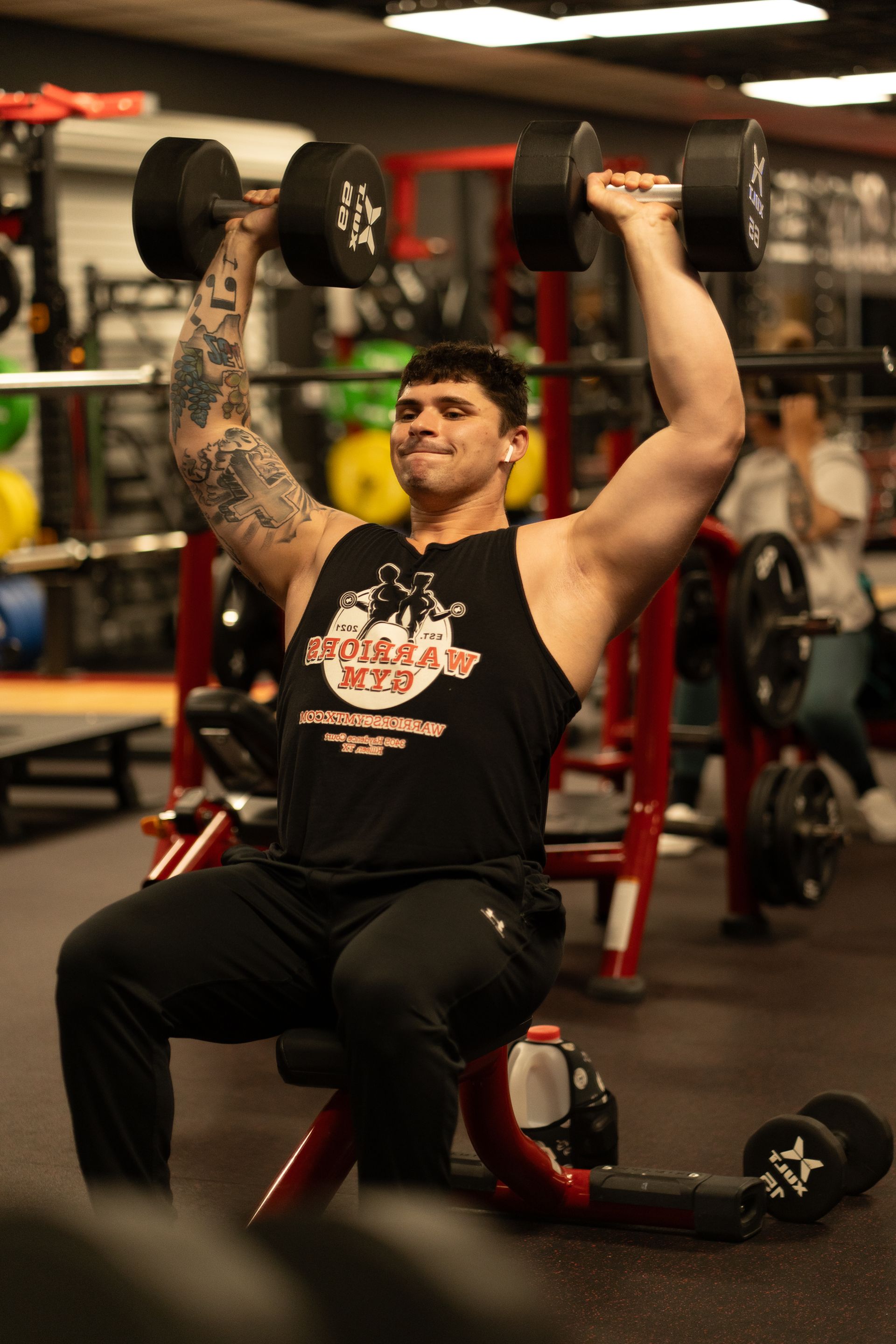Young active strong muscular sweaty man biceps muscle workout training