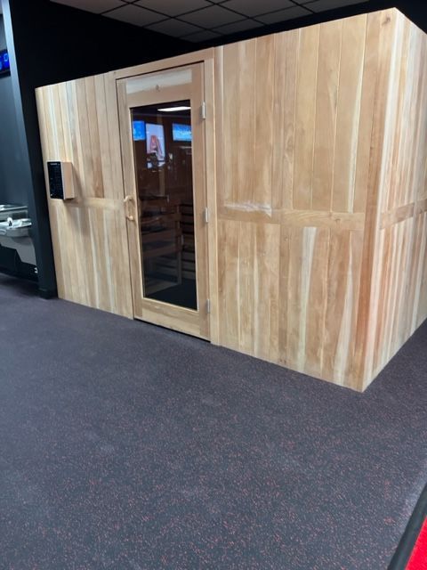 A wooden room with a door and a window