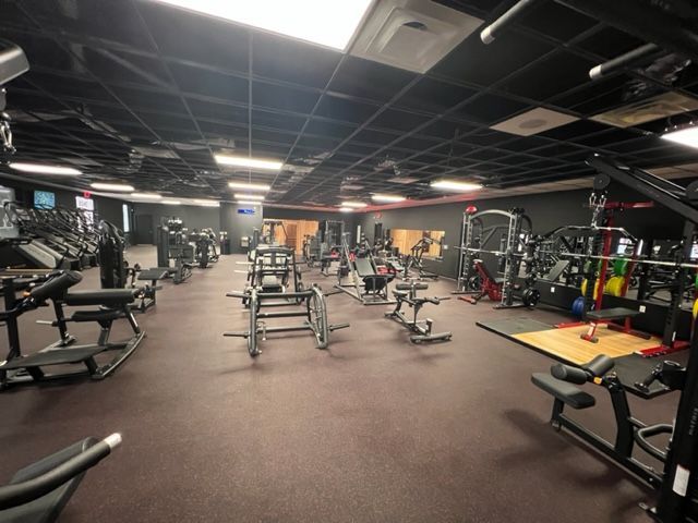 A large gym filled with lots of exercise equipment