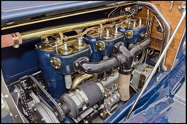 A close up of the engine of an old car