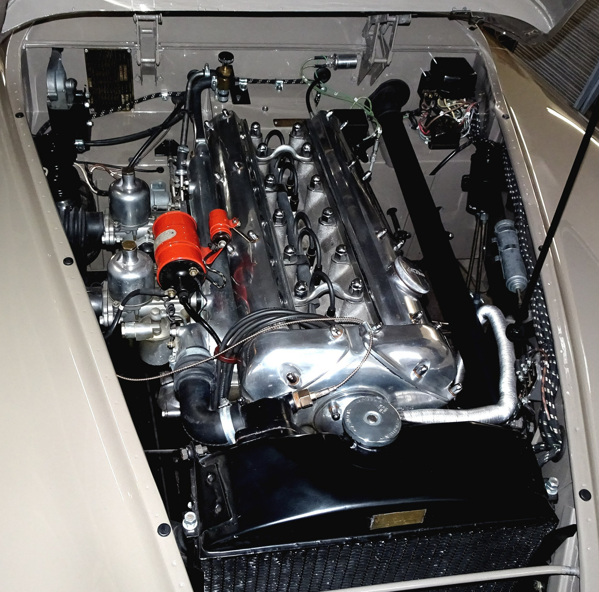 A close up of a car engine with the hood open