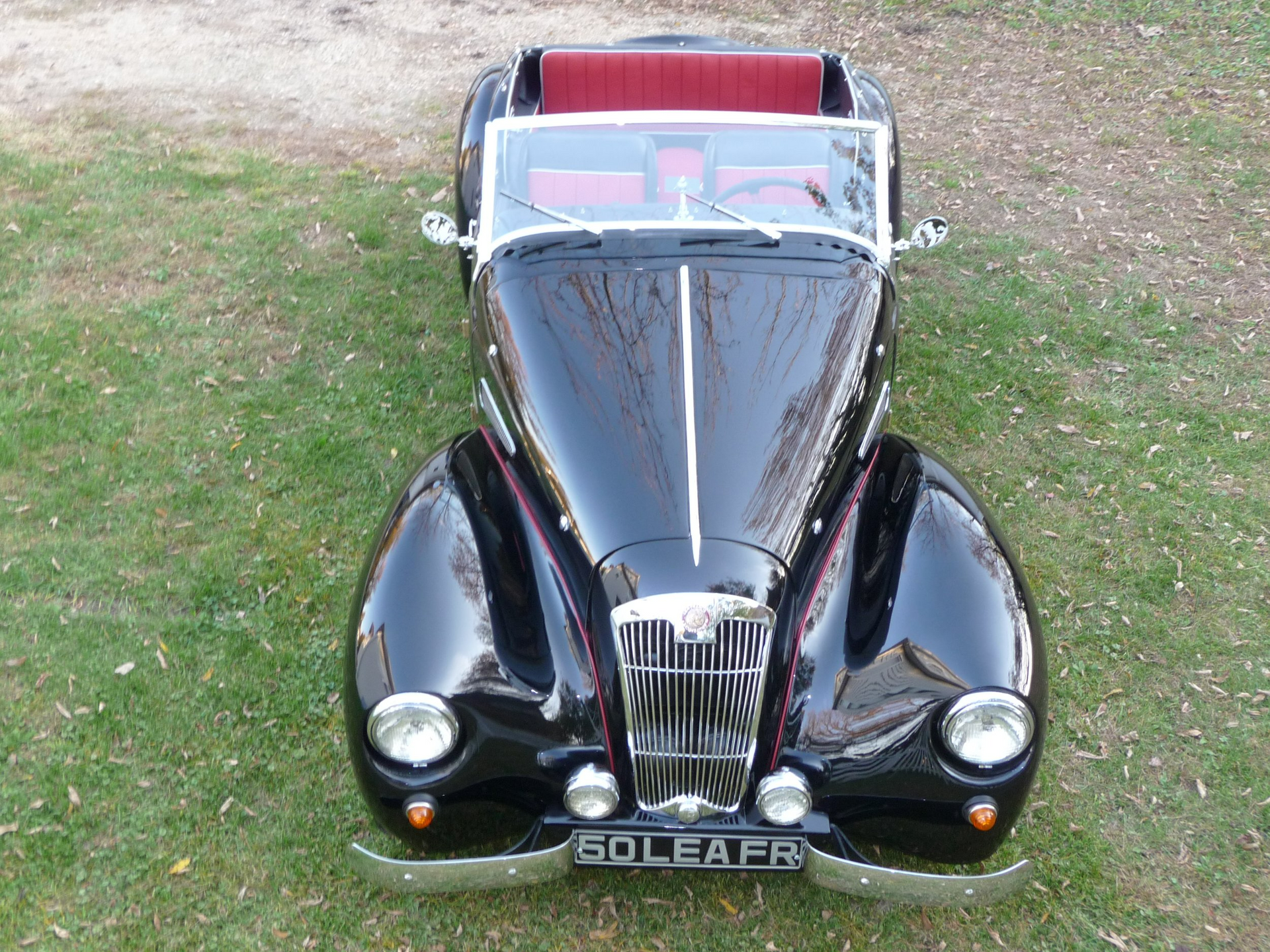 A black car with a license plate that says soleara