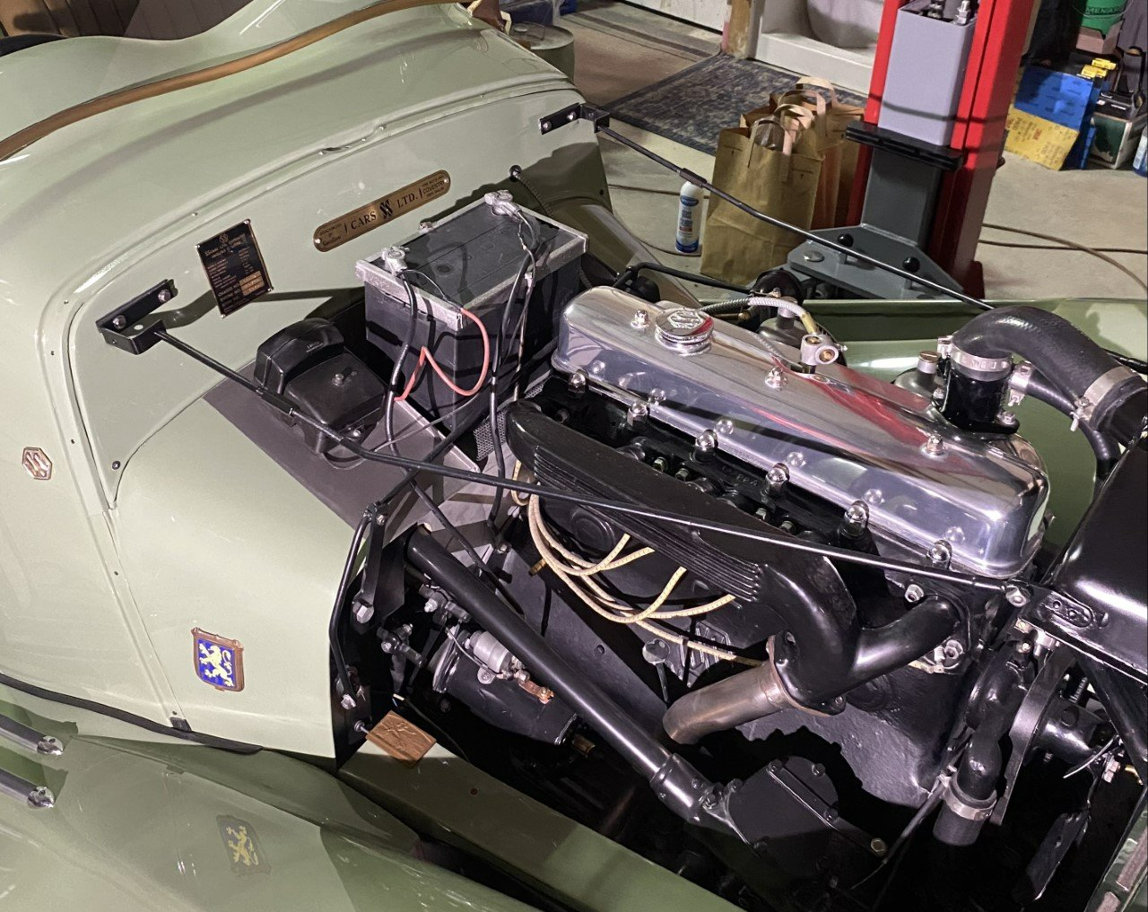 A close up of a car engine in a garage.