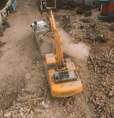 An aerial view of a construction site with a crane and a truck.