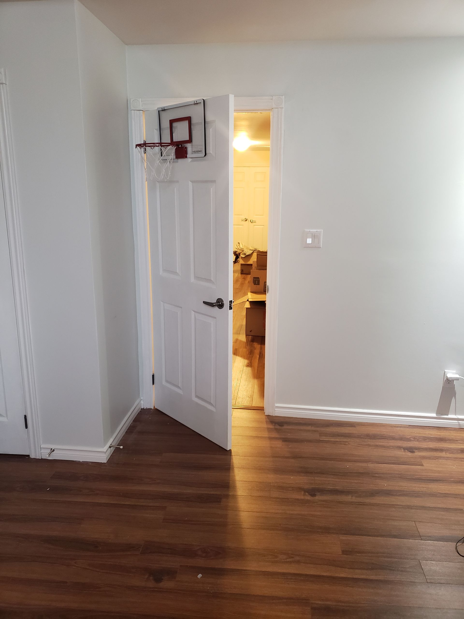 There is a basketball hoop on the wall above the door.