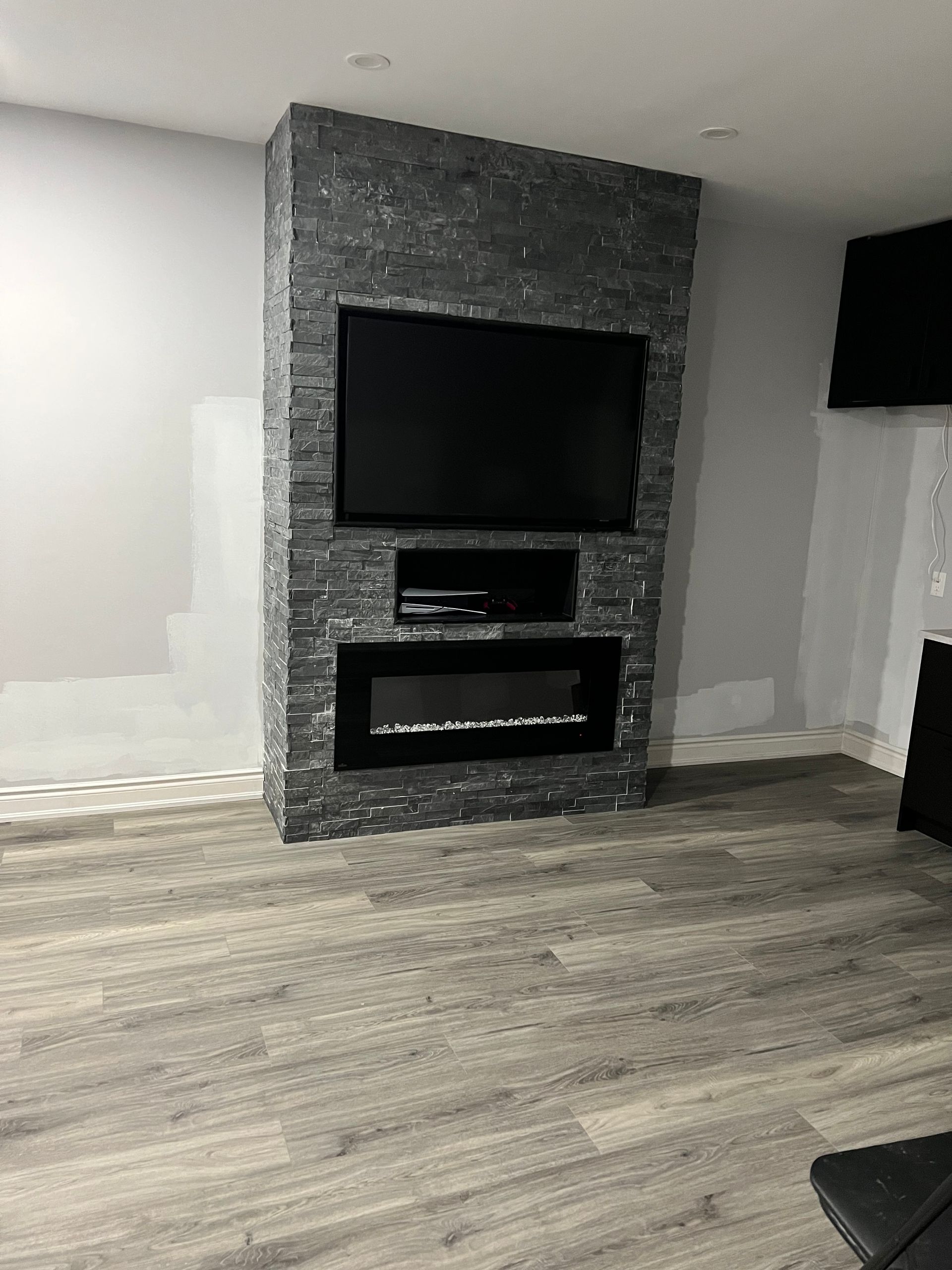 A living room with a fireplace and a flat screen tv.