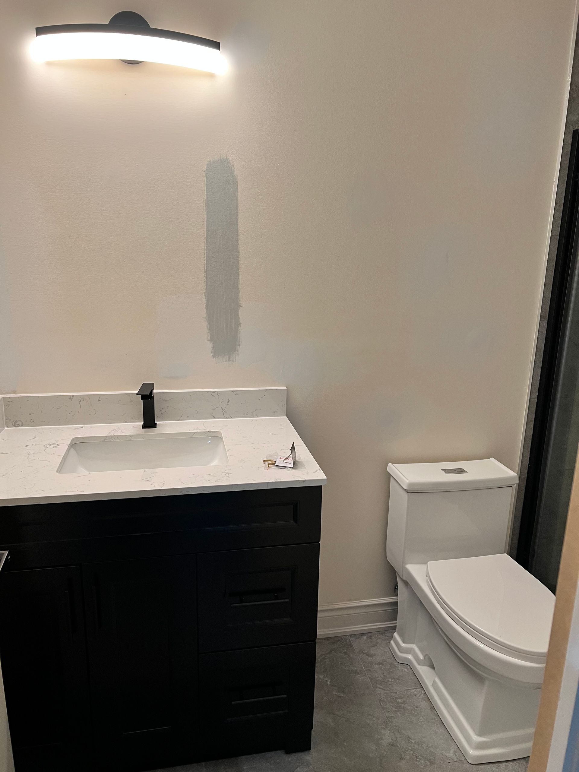 A bathroom with a sink , toilet and shower.