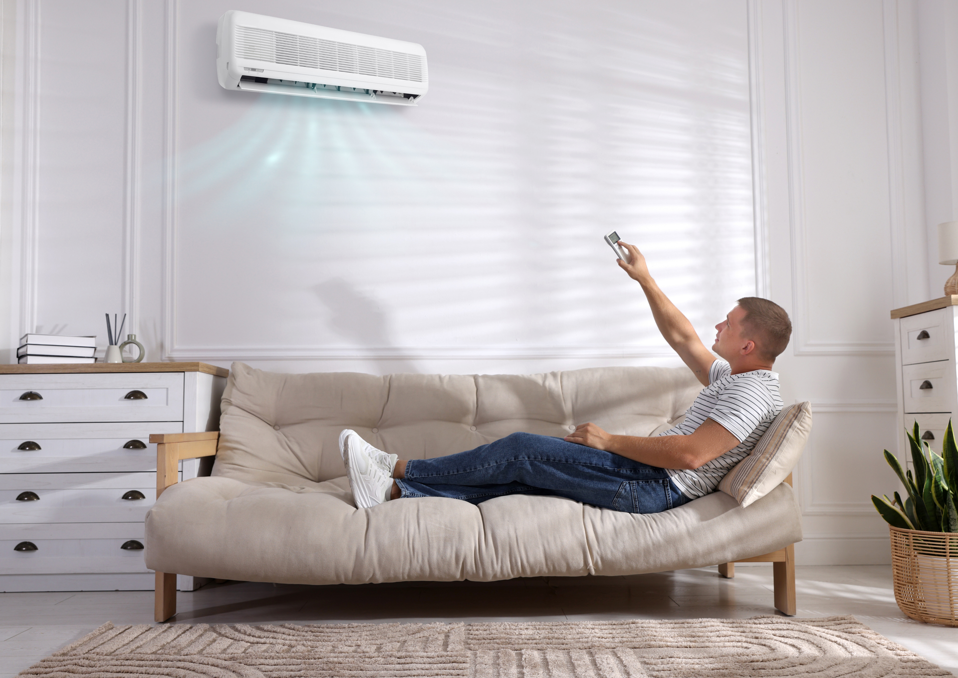 Two technicians in blue uniforms near an AC unit and tools in front of sliding glass doors.