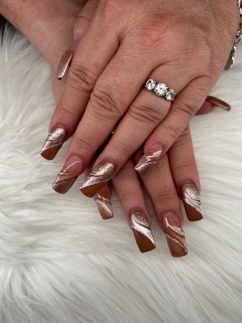 A close up of a woman 's nails with a ring on her finger