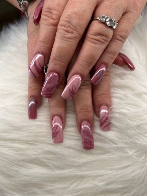A close up of a woman 's nails with a ring on her finger