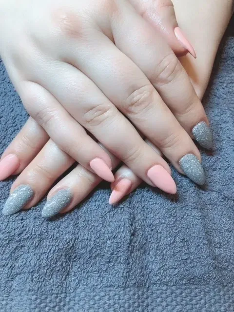 A close up of a woman 's nails with blue and white french manicure