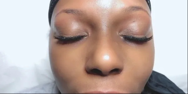 A close up of a woman 's face with her eyes closed.