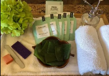 A tray with towels and a box that says pedi on it