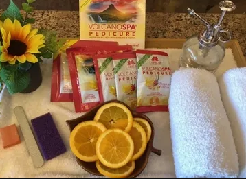 A tray with sliced oranges and a pamphlet for volcano spa pedicure