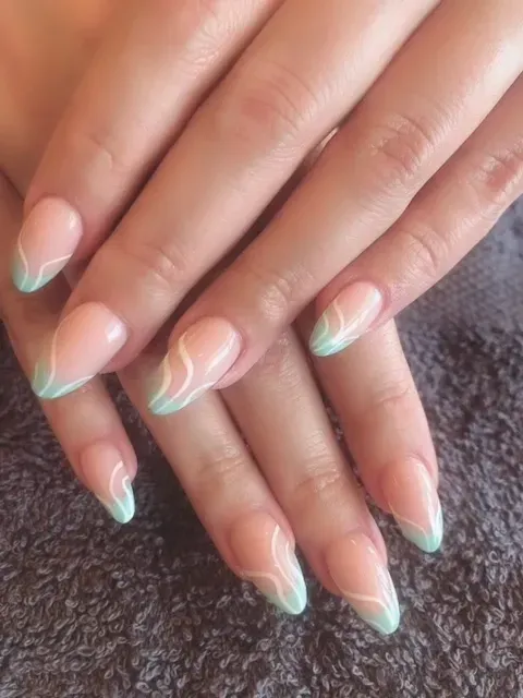 A close up of a woman 's nails with a french manicure