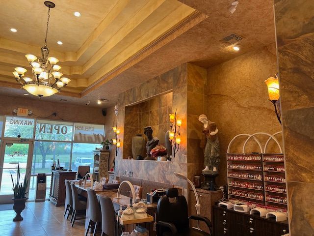 A nail salon with a chandelier hanging from the ceiling