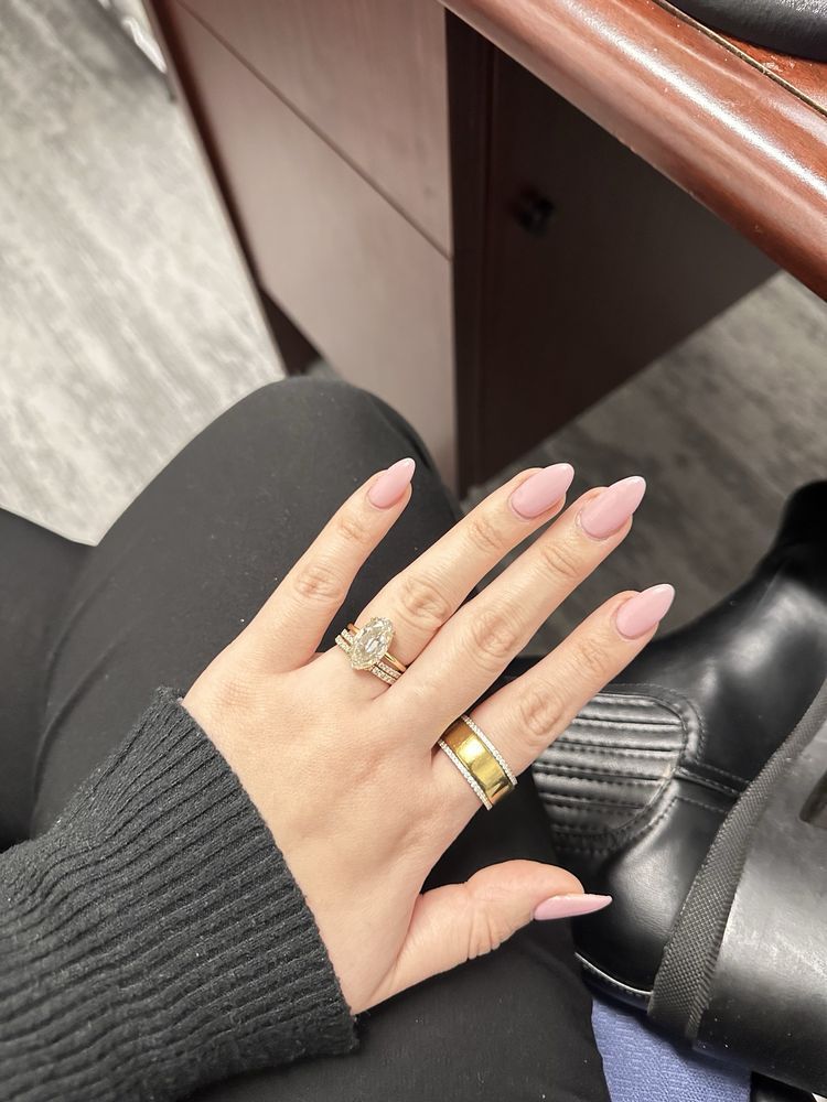 A close up of a woman 's hand with a ring on it