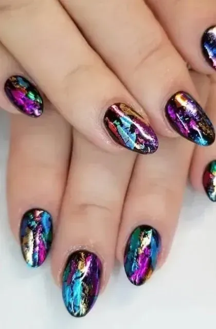 A close up of a woman 's nails with a colorful design