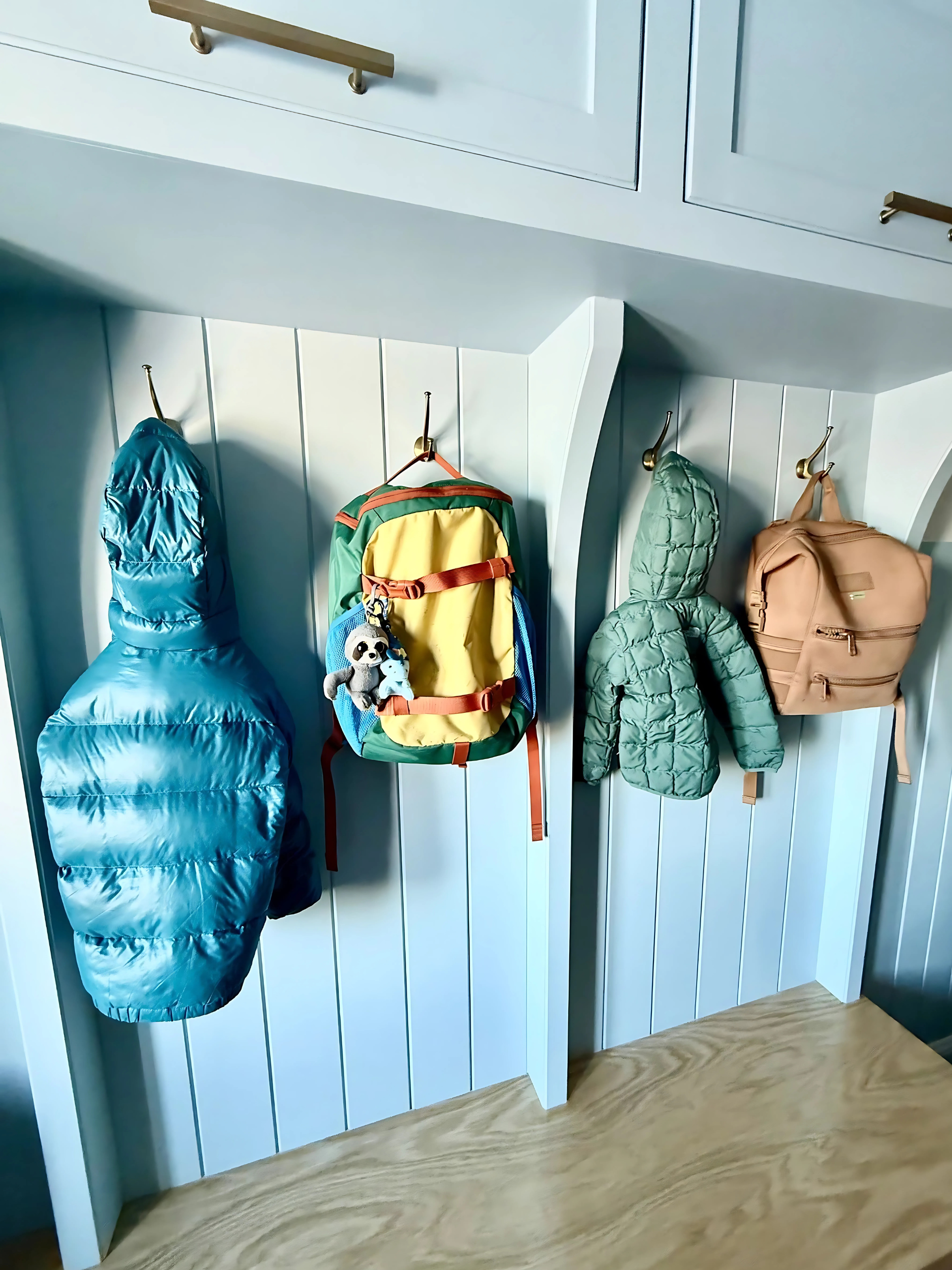 A kitchen with wooden cabinets , stainless steel appliances , and a large island.
