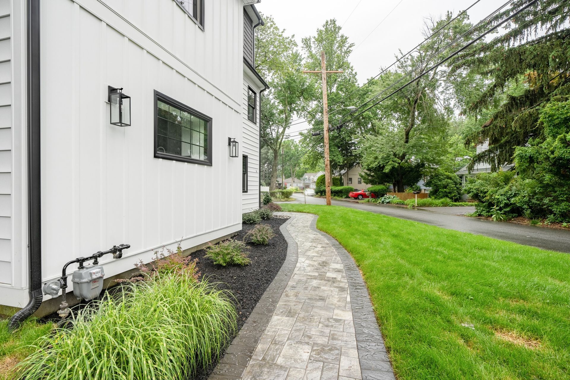 There is a walkway leading to the side of the house.