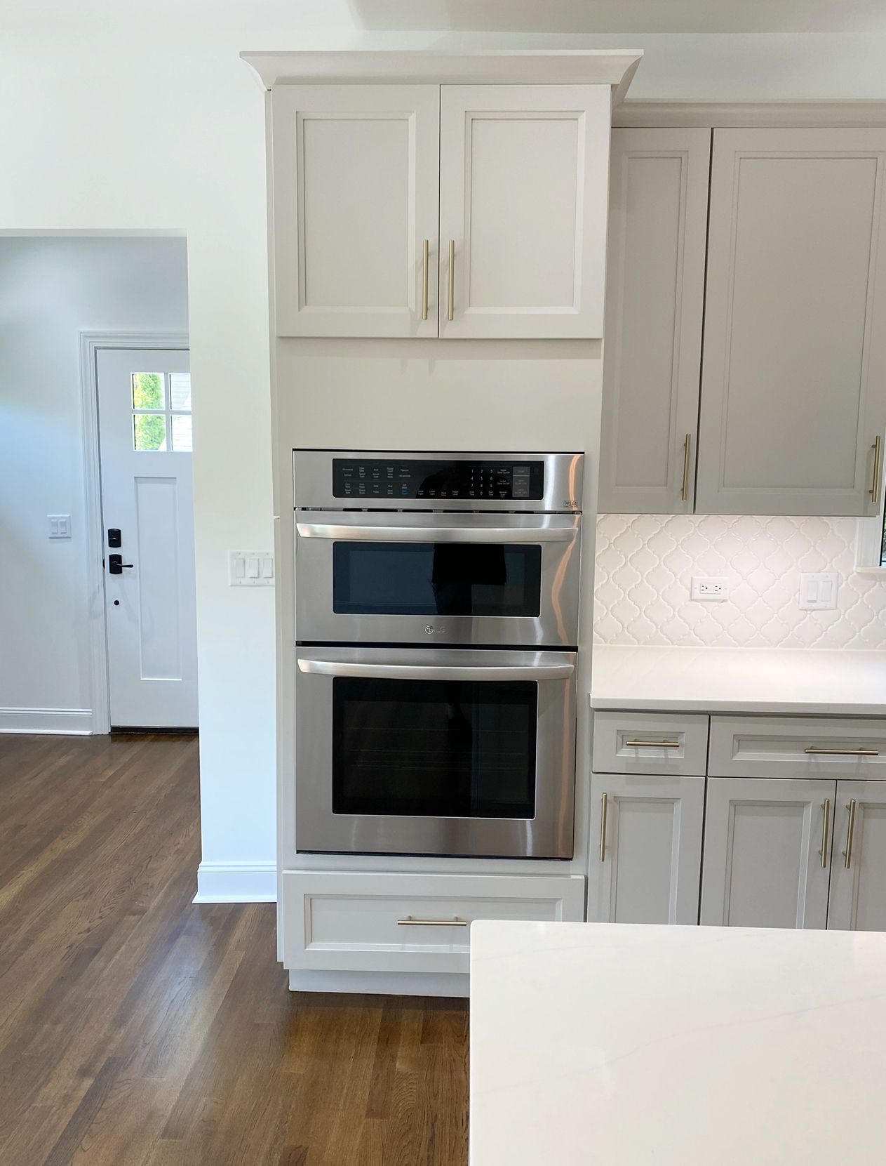 A kitchen with stainless steel appliances and white cabinets