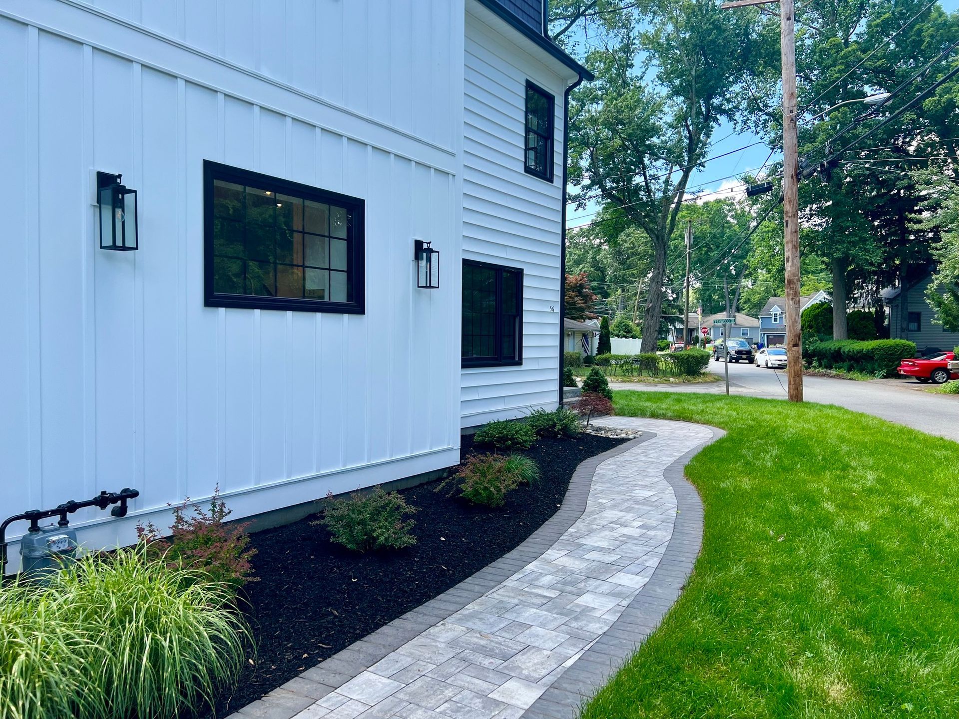 A white house with a walkway leading to it.
