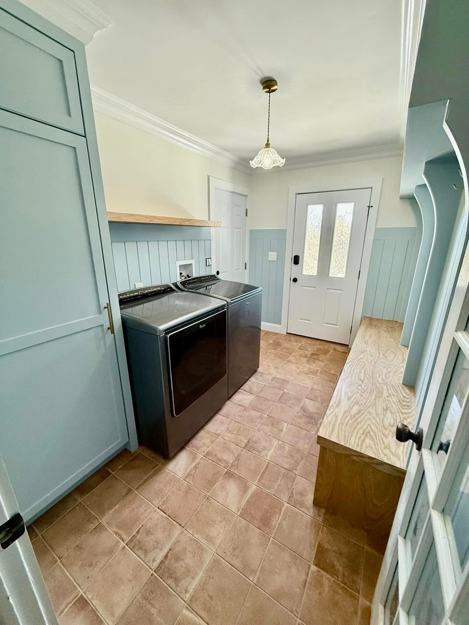 A kitchen with a stove , sink , and oven.