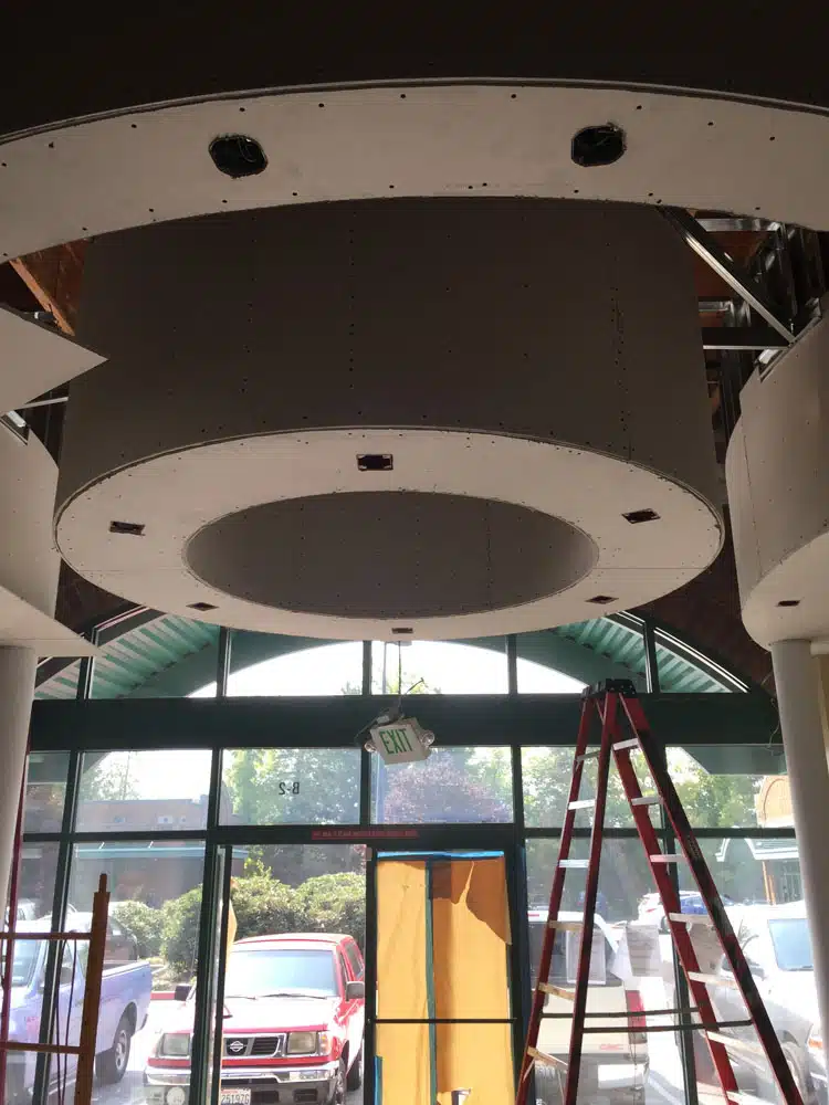 A large round ceiling with a ladder in front of it