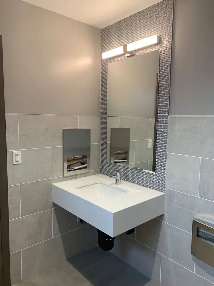 A bathroom with a sink and a mirror.