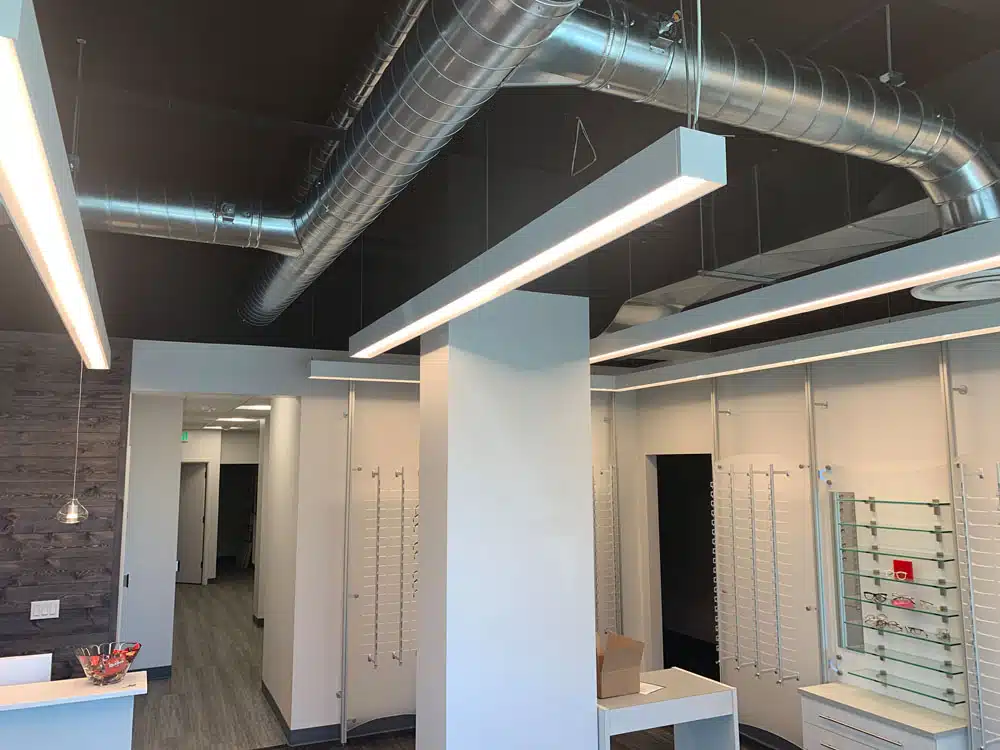 A large room with a lot of lights hanging from the ceiling.