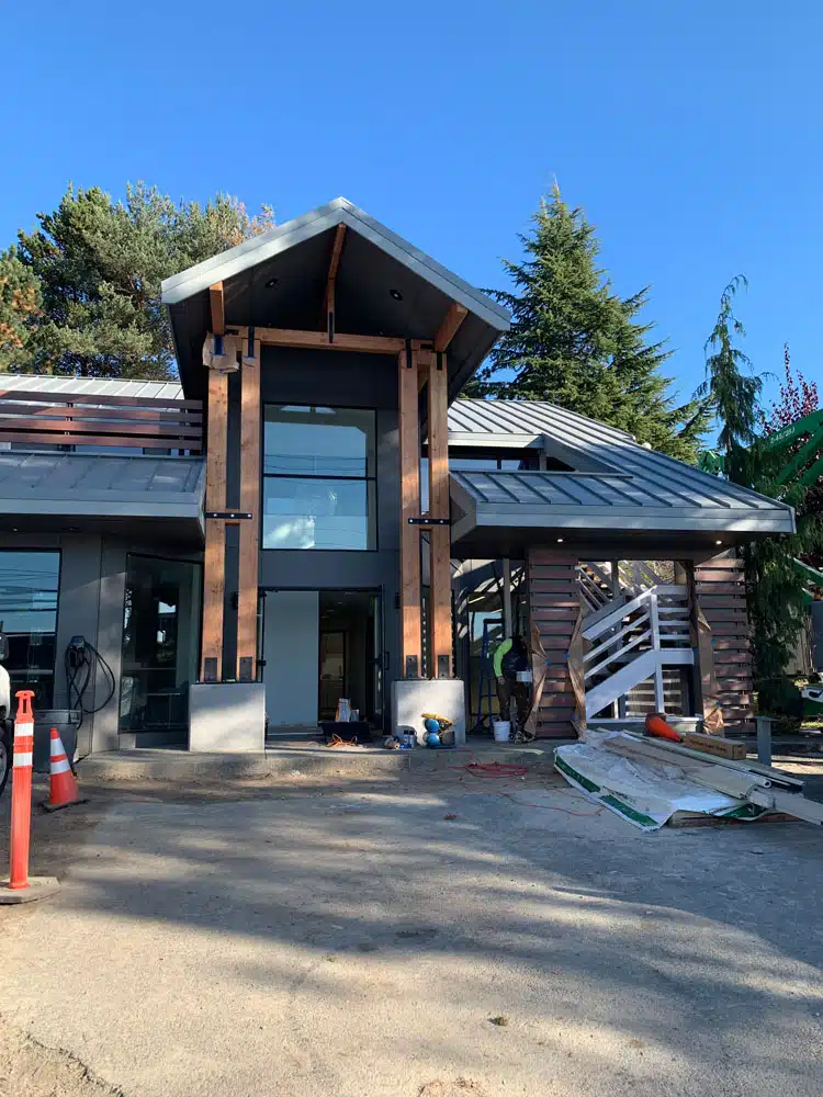A large house with a lot of windows is being built.
