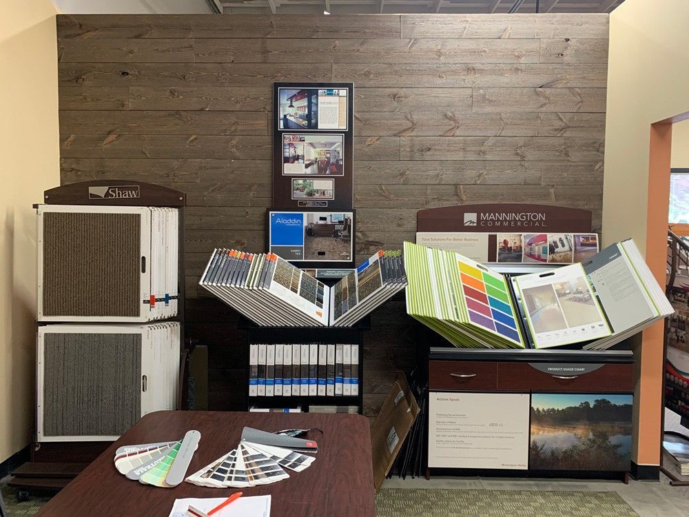 A room with a wooden wall and a table with a bunch of books on it