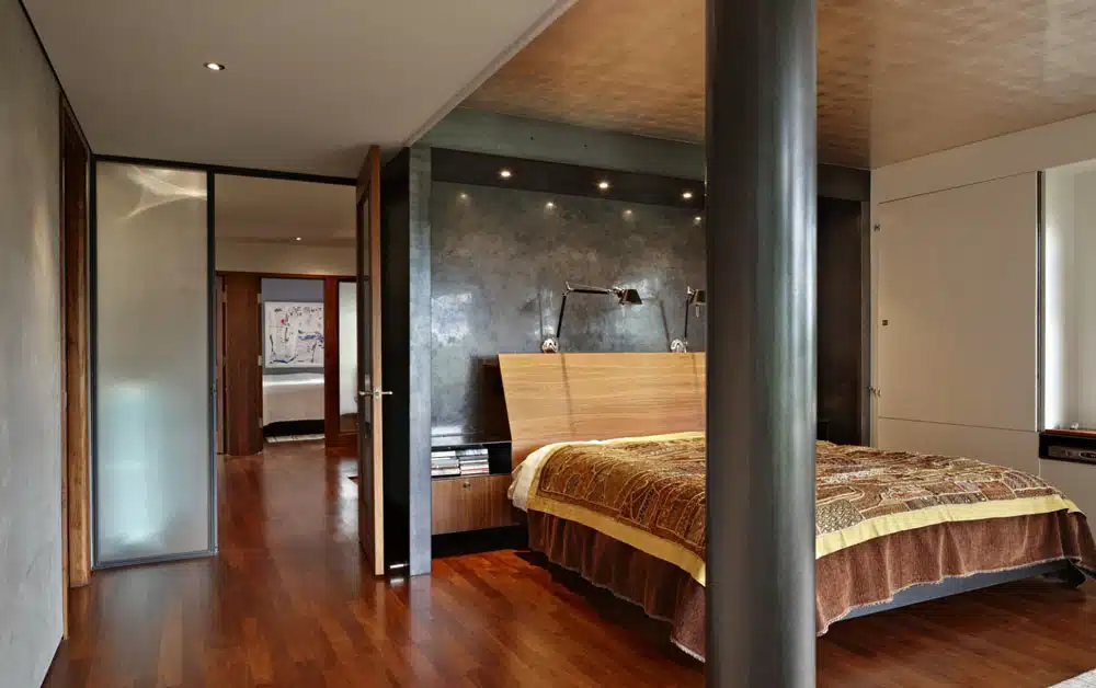 A bedroom with a bed and a sliding glass door