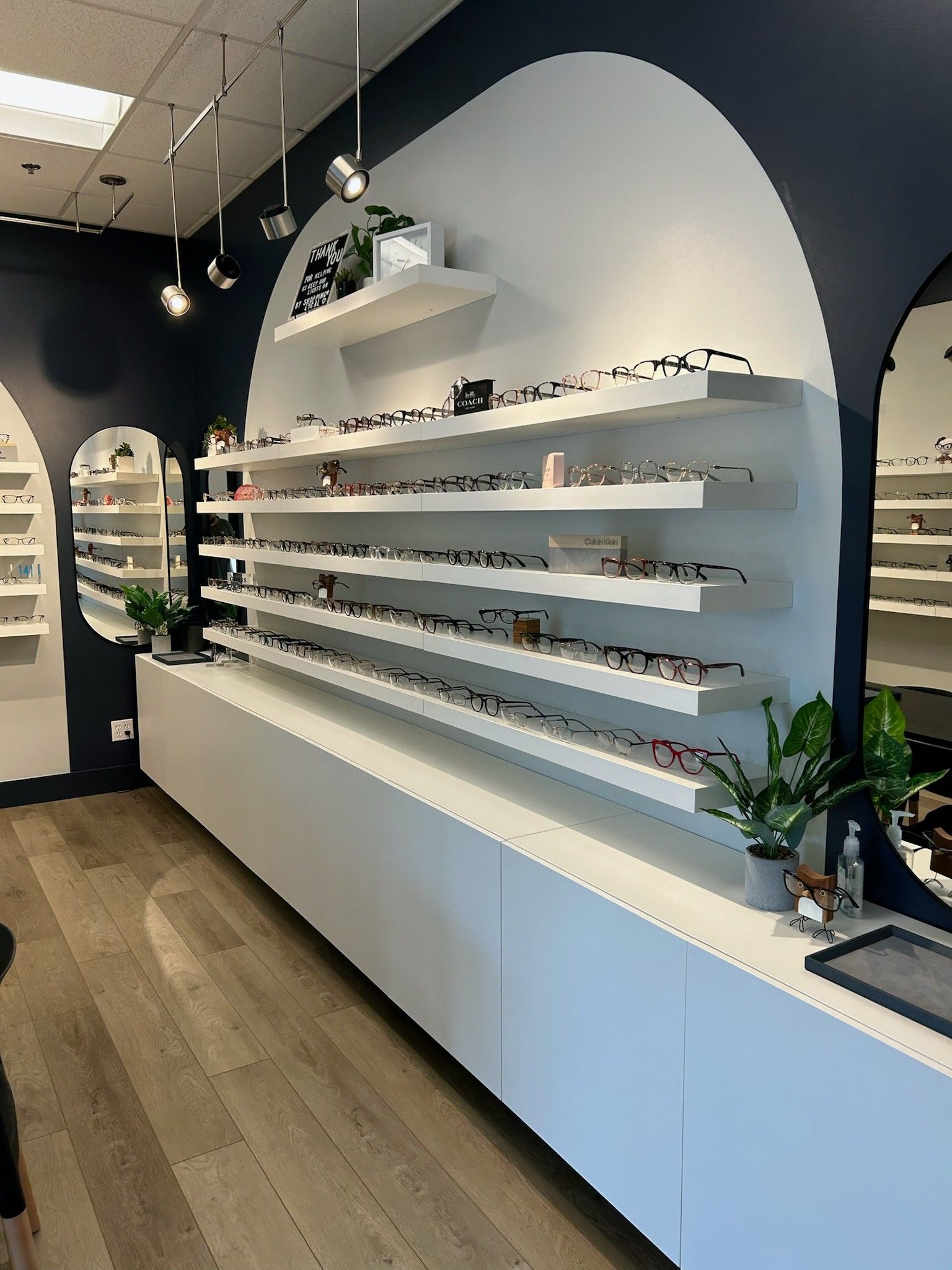 A row of shelves filled with glasses in an optical shop.